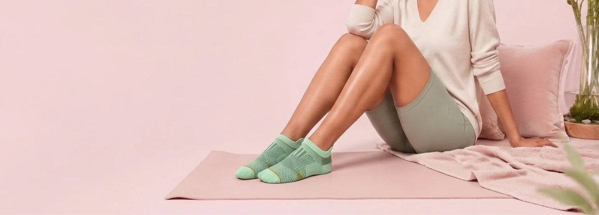 Woman wearing premium bamboo ankle socks in a soft studio setting.