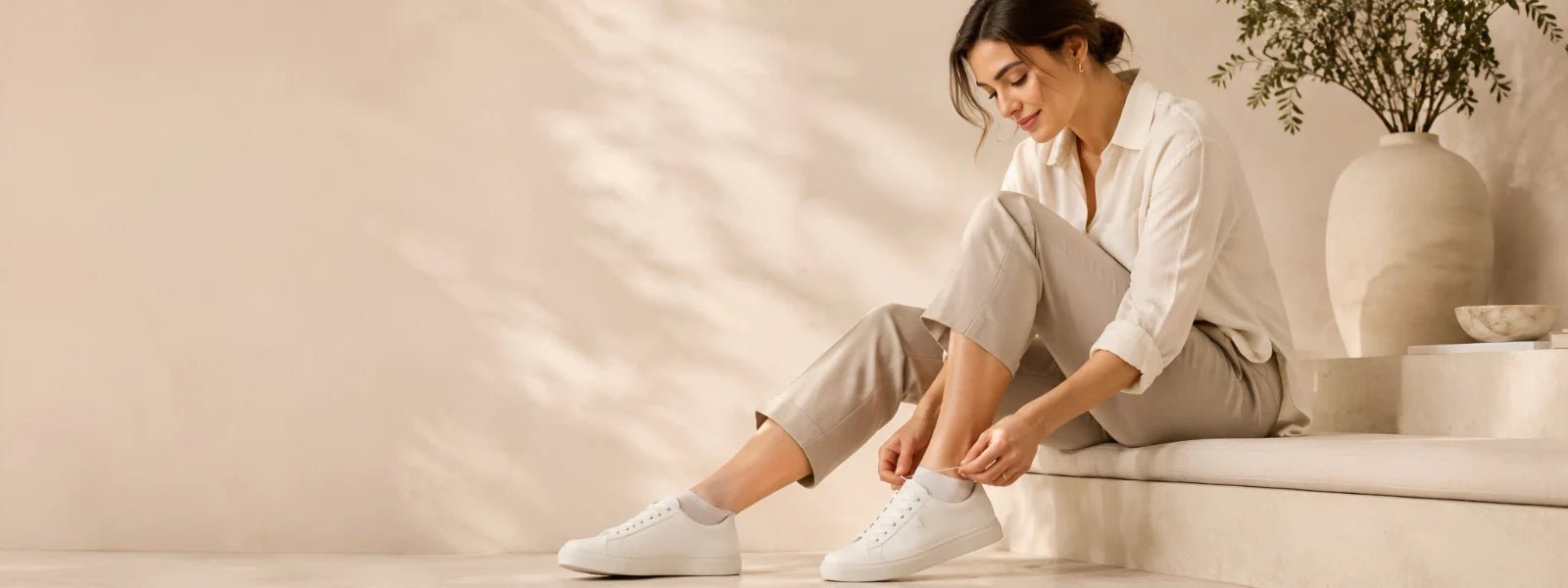Woman wearing white ankle socks with sneakers in a premium minimalist lifestyle setting | Uniq Socks Australia