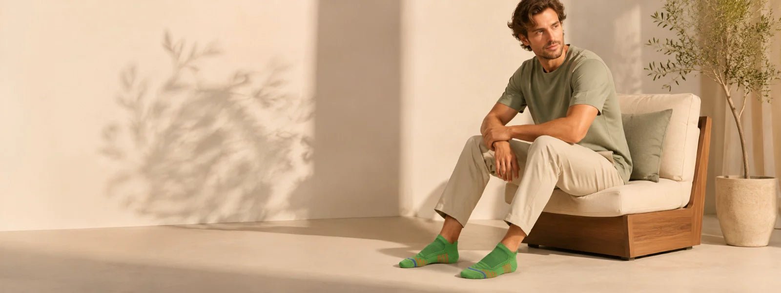 Man wearing green ankle socks in a premium lifestyle setting | Uniq Socks Australia