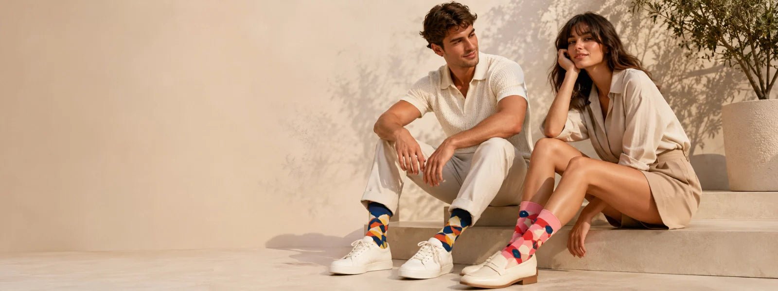 Man and woman wearing colourful patterned socks in a premium lifestyle setting | Uniq Socks Australia