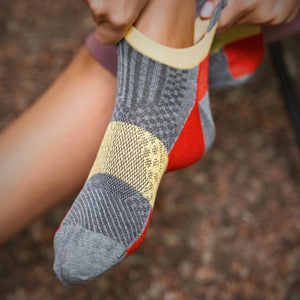 person wearing bamboo red athletic sneaker sock with heel tab