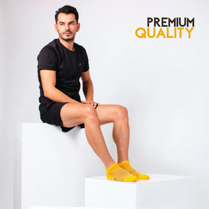 Man wearing yellow athletic sock for running and golf with heel tab