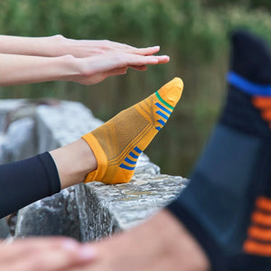 Person wearing mandarin bamboo sneaker sock with blue stripes