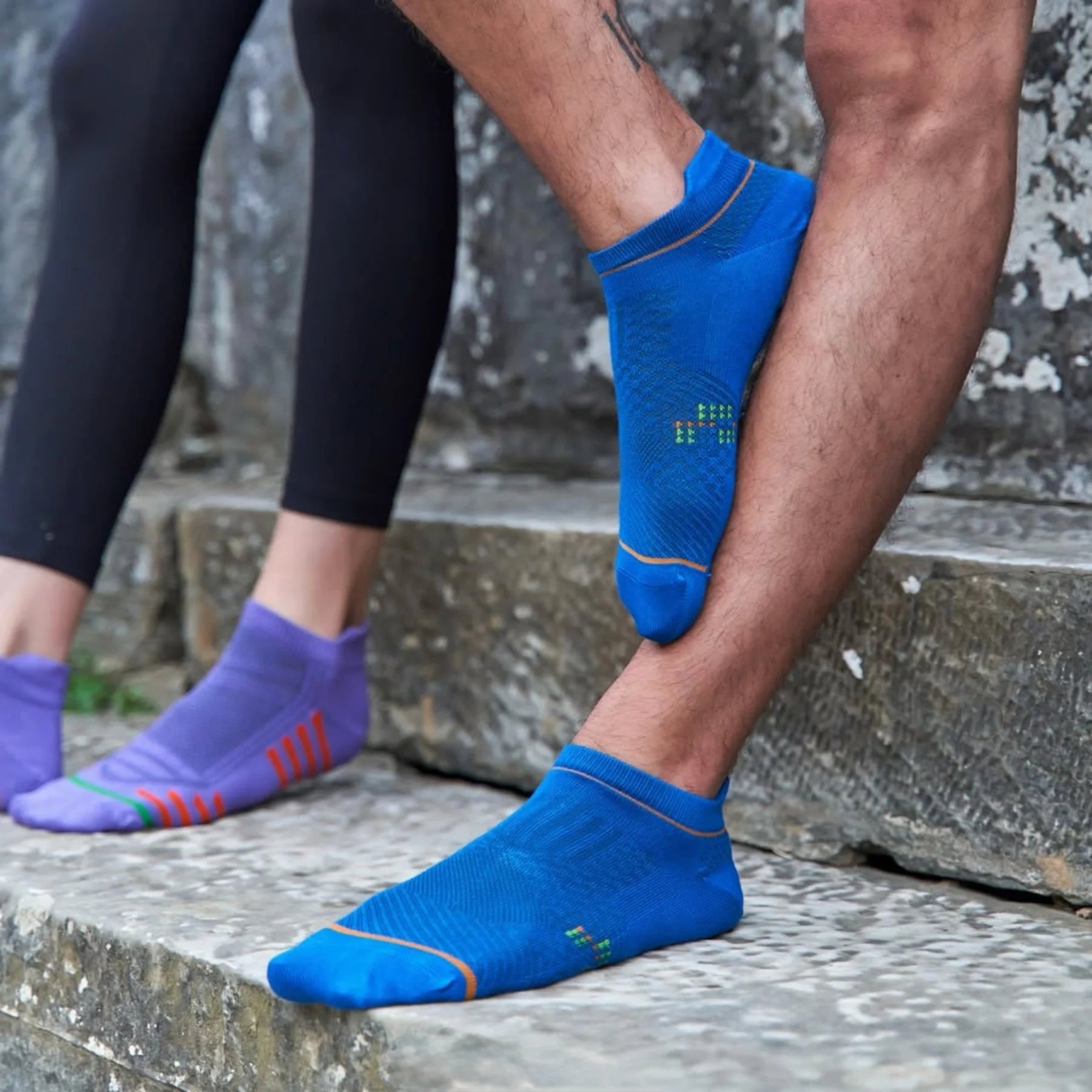 Man wearing blue athletic sock for running and golf with heel tab