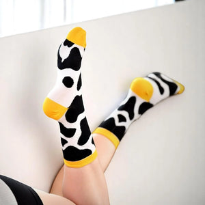 Woman wearing yellow cow themed socks