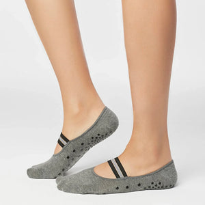 image of woman wearing grey yoga socks