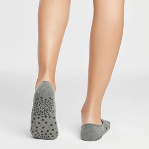 image of woman wearing grey yoga socks