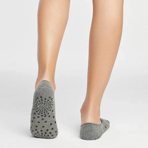 image of woman wearing grey yoga socks