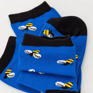 photo of light blue crew socks with honey bee images