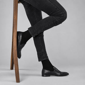 Black bamboo crew socks for men styled with slim jeans and leather shoes, premium breathable everyday socks by Uniq Socks