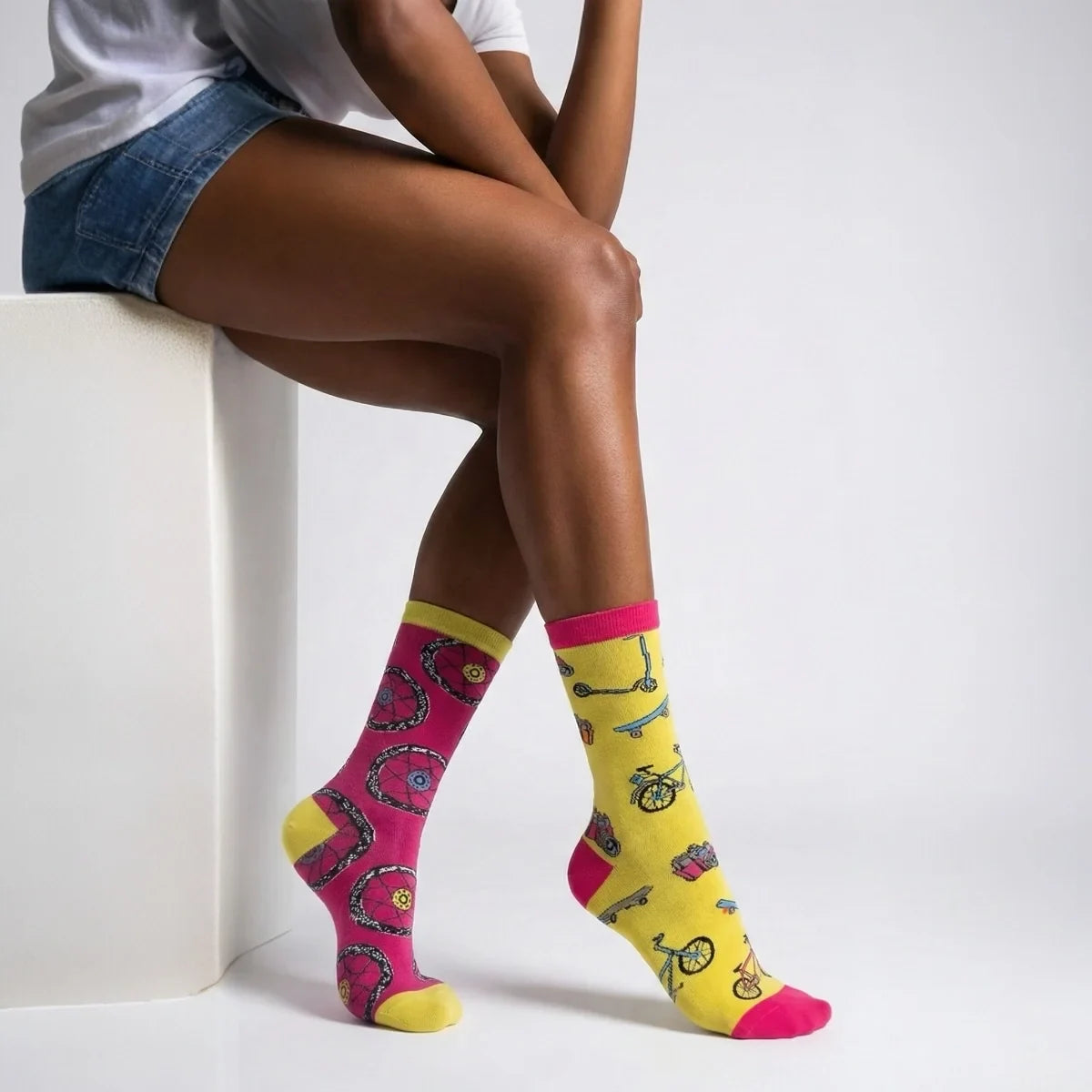 Person wearing bicycle themed socks with a white background