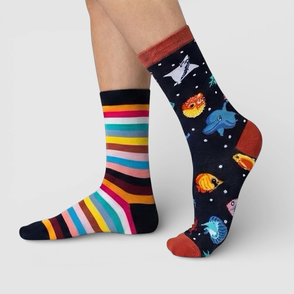 Colourful striped and marine themed socks on a plain background