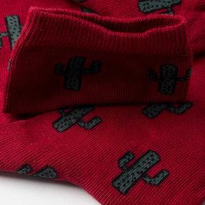 Close-up image of burgundy coloured crew socks with cactus images