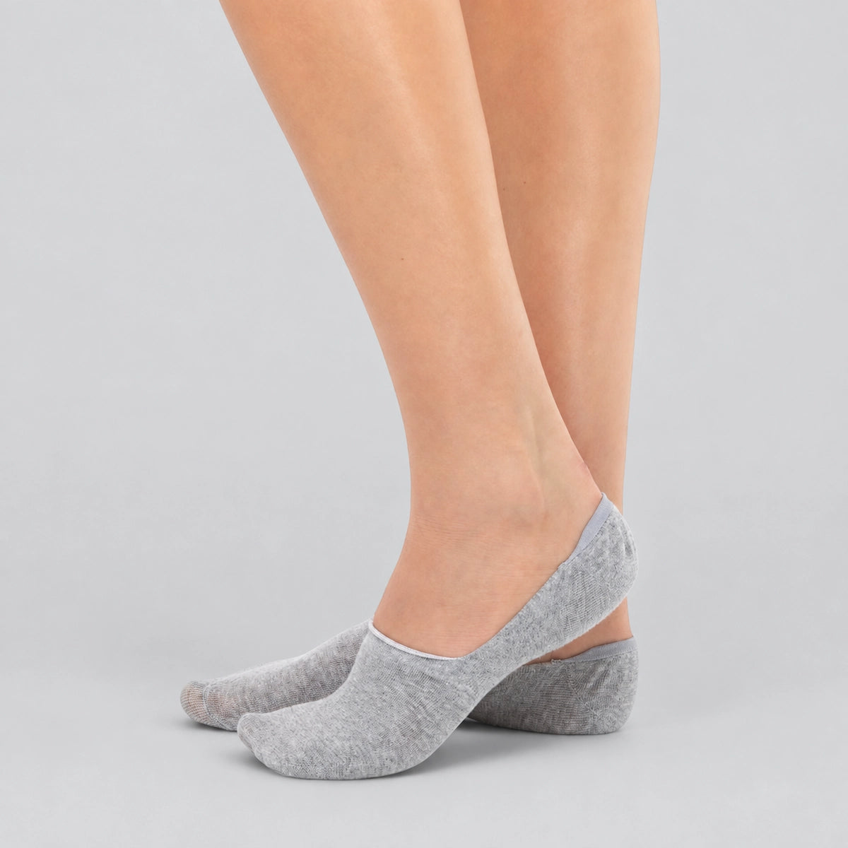 Light grey bamboo no-show socks worn on feet demonstrating invisible low-cut fit.