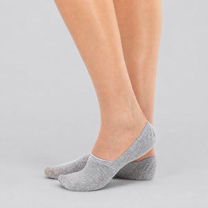 Light grey bamboo no-show socks worn on feet demonstrating invisible low-cut fit.
