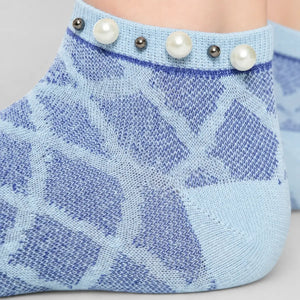 A woman wearing blue checked ankle socks finished with pearls around the cuff