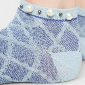 A woman wearing blue checked ankle socks finished with pearls around the cuff