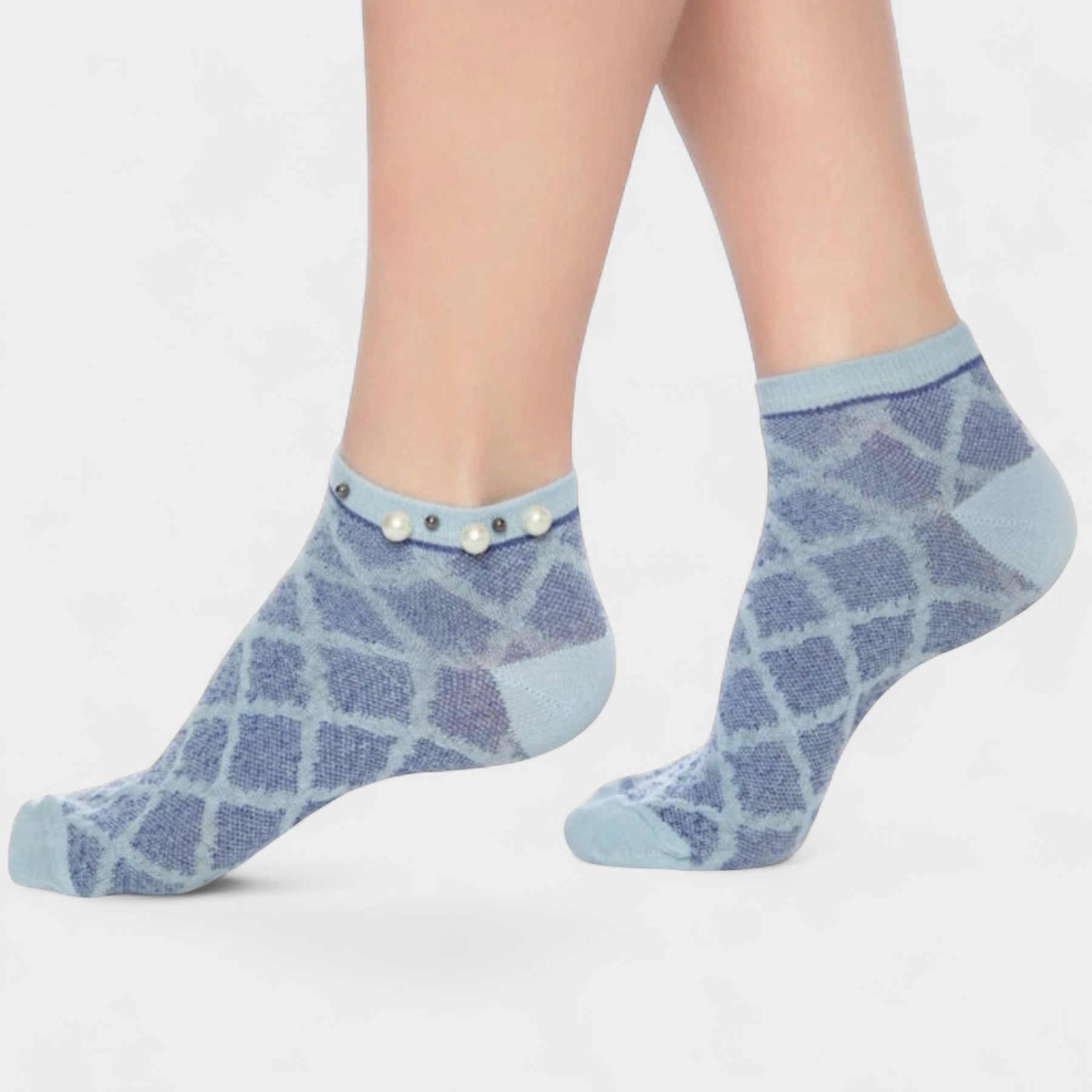 A woman wearing blue checked ankle socks finished with pearls around the cuff