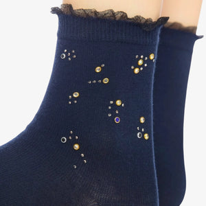 Person wearing blue quarter length socks with crystal details and a frilled cuff
