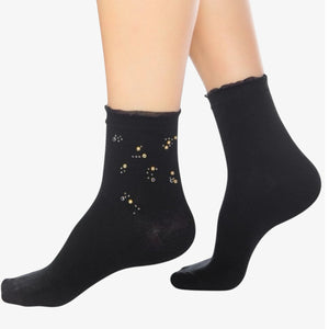 Person wearing black quarter length socks with crystal details and a frilled cuff