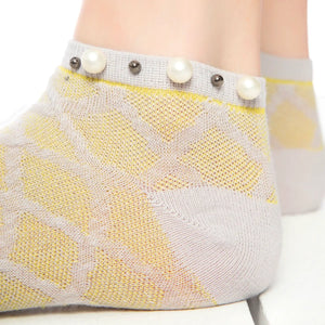 A woman wearing grey checked ankle socks finished with pearls around the cuff