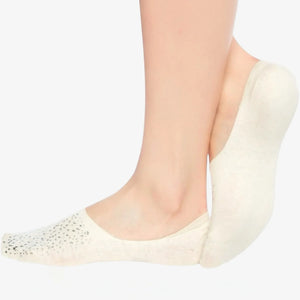 Person wearing ivory coloured no-show, anti-slip socks with sparkly details