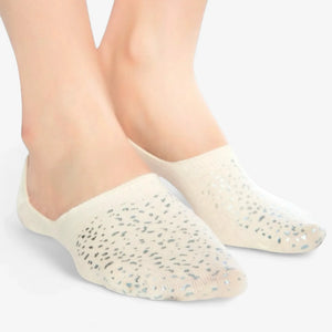 Person wearing ivory coloured no-show, anti-slip socks with sparkly details
