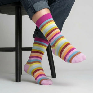 Person wearing colorful striped socks on a light background