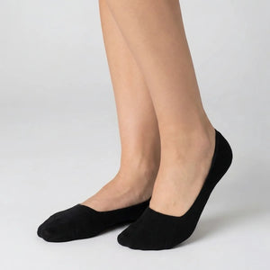 Woman wearing black no-show socks on light grey background