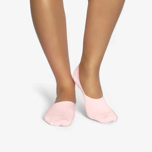 Person wearing seamless pink bamboo no-show socks on a white background