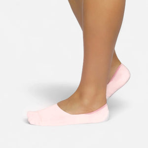Person wearing seamless pink bamboo no-show socks on a white background