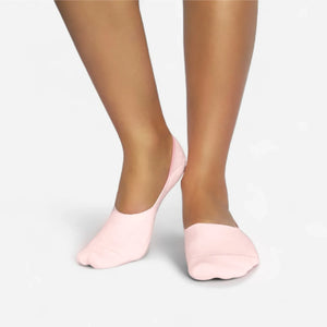 Person wearing seamless pink bamboo no-show socks on a white background