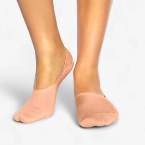Person wearing salmon bamboo no-show socks on a light grey background