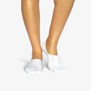Person wearing seamless white bamboo no-show socks on a white background