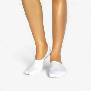 Person wearing seamless white bamboo no-show socks on a white background
