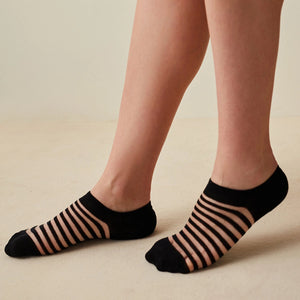 woman wearing sheer, black striped ankle socks