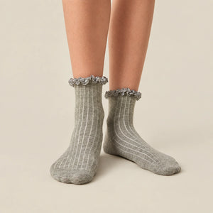 Woman wearing grey ribbed quarter length socks with gingham ruffle