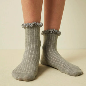 Woman wearing grey ribbed quarter length socks with gingham ruffle