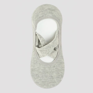 grey yoga socks with crisscross straps on a neutral background