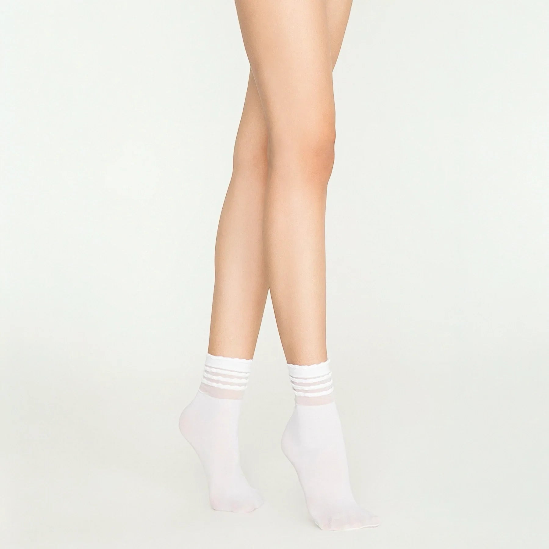 Woman wearing sheer white ruffled socks