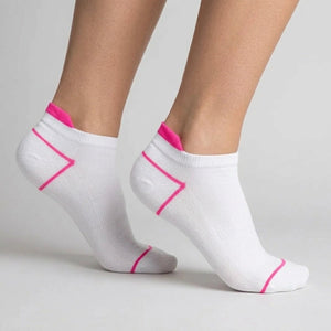 White ankle socks with pink accents worn by a person on a light grey background