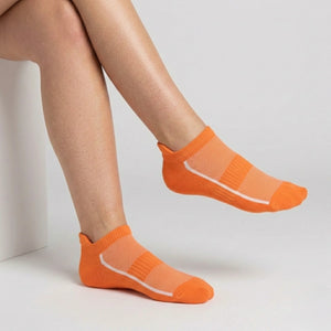 Orange ankle socks with mesh design worn by a person on a light gray background