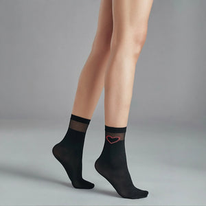 person wearing sheer black crew socks with striped cuff and loveheart detail