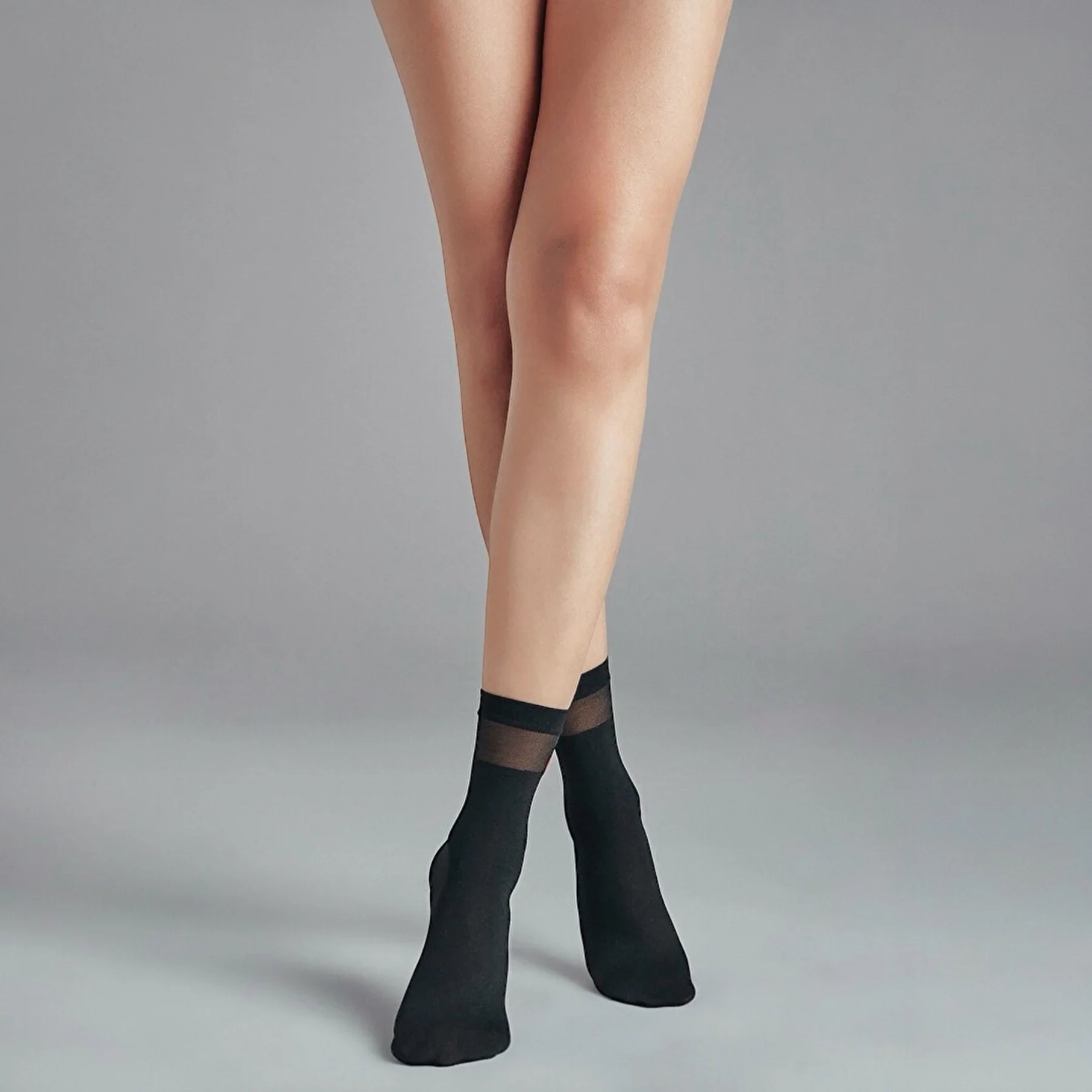 person wearing sheer black crew socks with striped cuff and loveheart detail