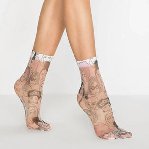 Transparent socks with tattoo-style designs worn by a person on a plain background