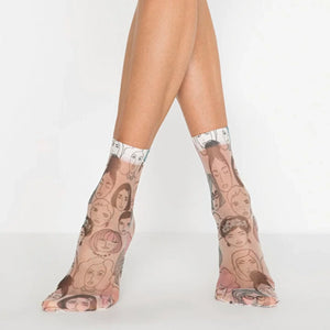 Sheer patterned ankle socks with face designs worn by a person on a white background