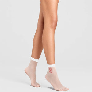 person wearing white sheer quarter length socks stating 'femme'