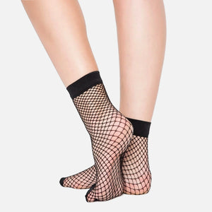 Person wearing black fishnet ankle socks