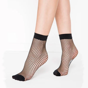 Person wearing black fishnet ankle socks