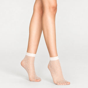 Woman's legs showing sheer white quarter length socks with small silver detail
